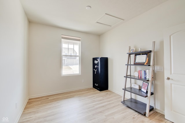 misc room with attic access, wood finished floors, and baseboards