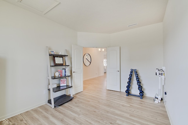 empty room with visible vents, light wood-style flooring, and baseboards