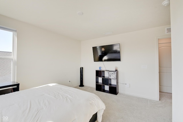 carpeted bedroom with visible vents and baseboards