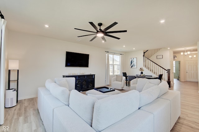 living area with ceiling fan, recessed lighting, light wood-style flooring, and stairs