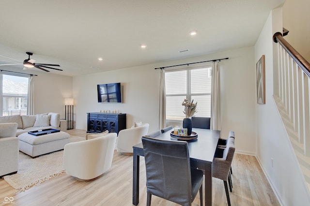 dining space featuring visible vents, light wood finished floors, recessed lighting, ceiling fan, and stairs