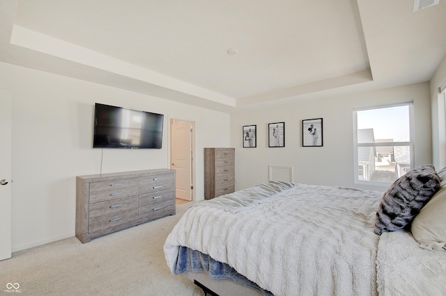 bedroom featuring baseboards, a raised ceiling, and carpet flooring