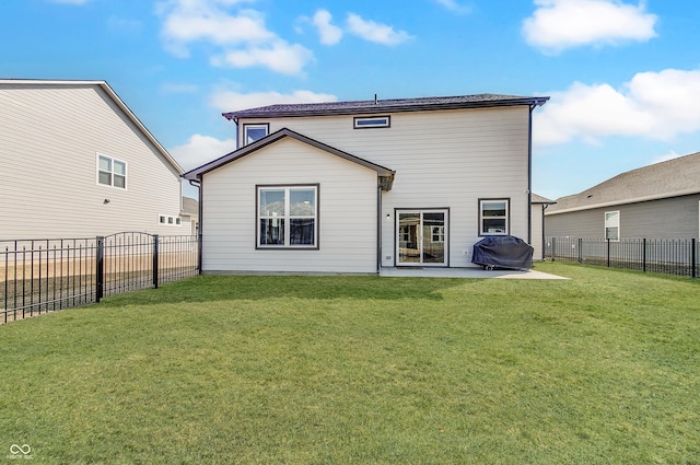 back of house featuring a yard, a fenced backyard, and a patio area