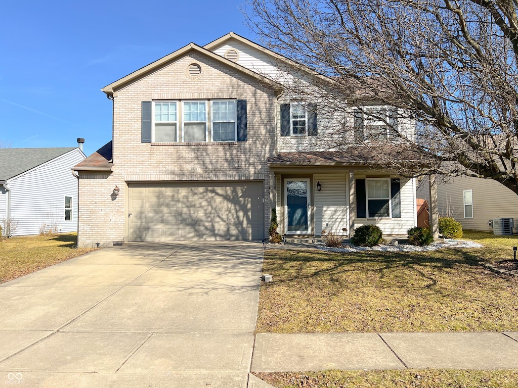 traditional home featuring brick siding, an attached garage, a front lawn, central air condition unit, and driveway