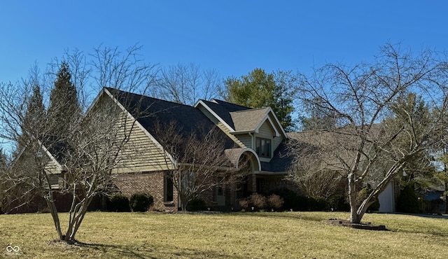 view of home's exterior with a lawn and brick siding