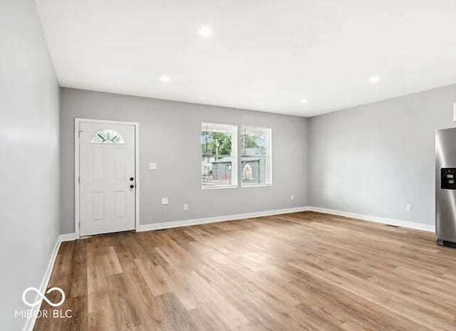 interior space with recessed lighting, light wood-style floors, and baseboards