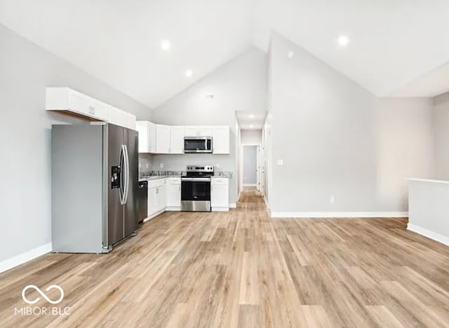 kitchen with baseboards, light wood finished floors, light countertops, appliances with stainless steel finishes, and white cabinetry