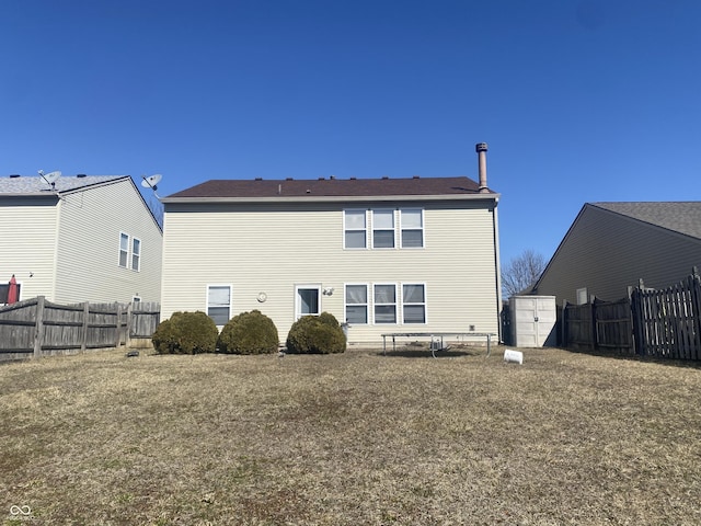 back of property with a storage shed, fence, and an outdoor structure