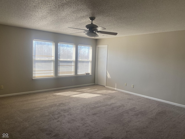 carpeted empty room featuring baseboards, a textured ceiling, and ceiling fan