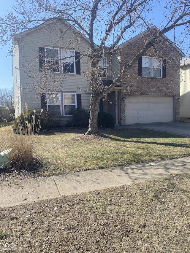 traditional home with a garage, driveway, and a front yard