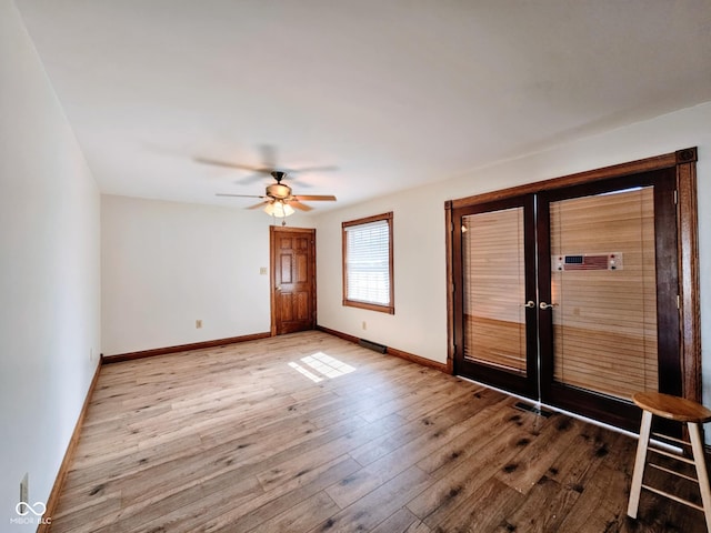 4109 E Epler Ave, Indianapolis, IN 46237 - unfurnished room featuring french doors, baseboards, hardwood / wood-style floors, and a ceiling fan
