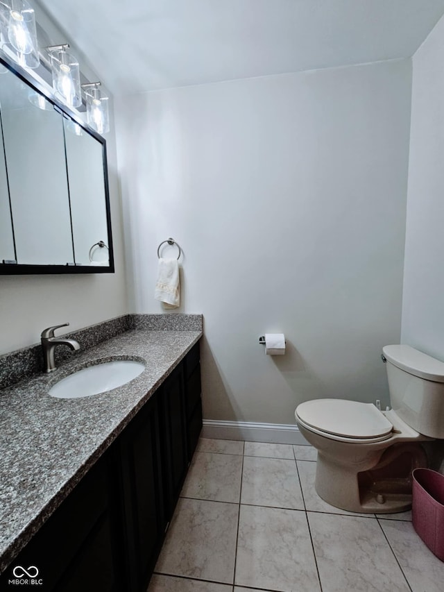 4109 E Epler Ave, Indianapolis, IN 46237 - half bath with vanity, tile patterned floors, toilet, and baseboards