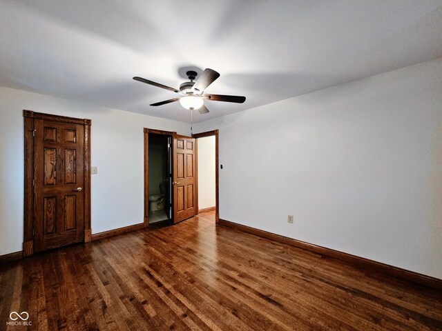 4109 E Epler Ave, Indianapolis, IN 46237 - unfurnished bedroom with connected bathroom, baseboards, dark wood-style flooring, and ceiling fan