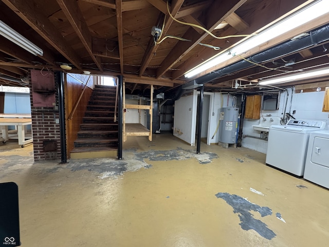 below grade area featuring independent washer and dryer, stairway, water heater, and a sink