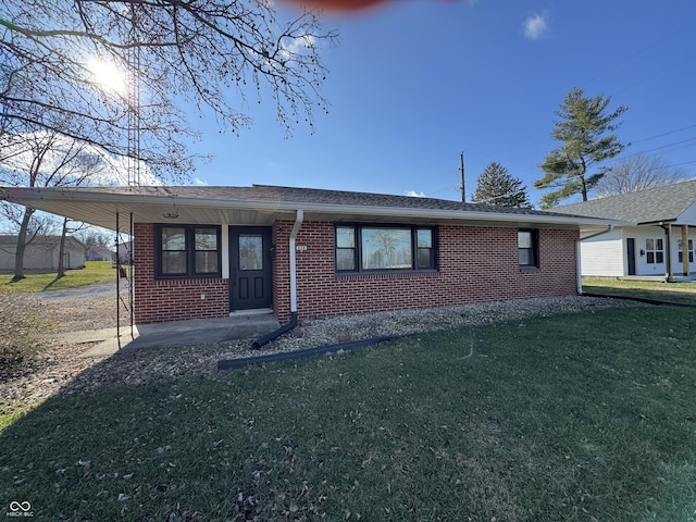 single story home with a carport, brick siding, roof with shingles, and a front lawn