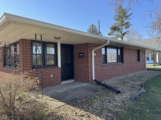 ranch-style home featuring brick siding