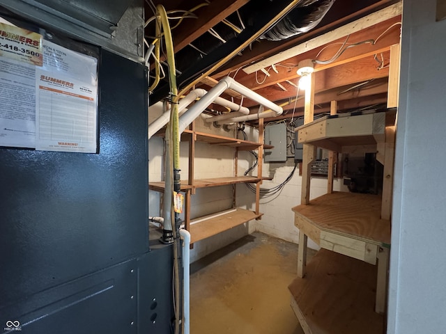 unfinished basement featuring electric panel and heating unit