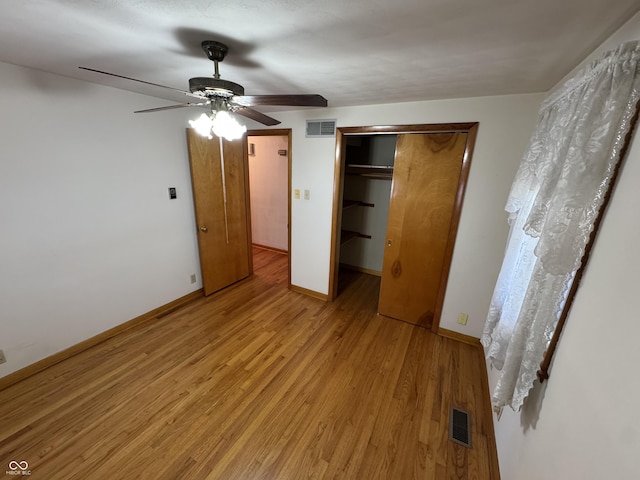 unfurnished bedroom featuring light wood finished floors, visible vents, ceiling fan, and baseboards