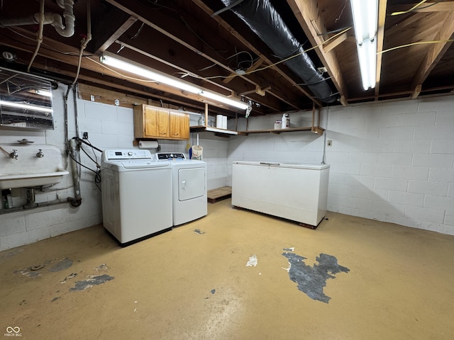 unfinished below grade area with a sink, refrigerator, and washer and dryer