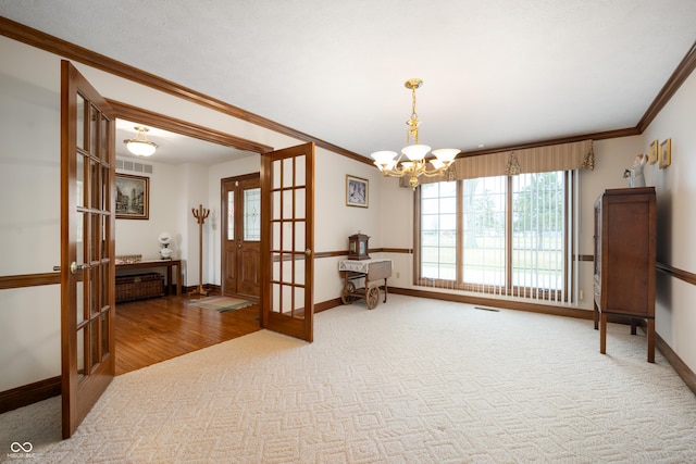 living area with carpet flooring, french doors, visible vents, and ornamental molding