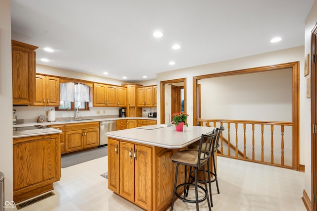 kitchen with visible vents, light floors, dishwasher, and a sink