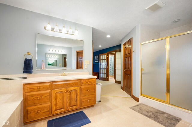 full bath featuring vanity, visible vents, recessed lighting, a stall shower, and french doors