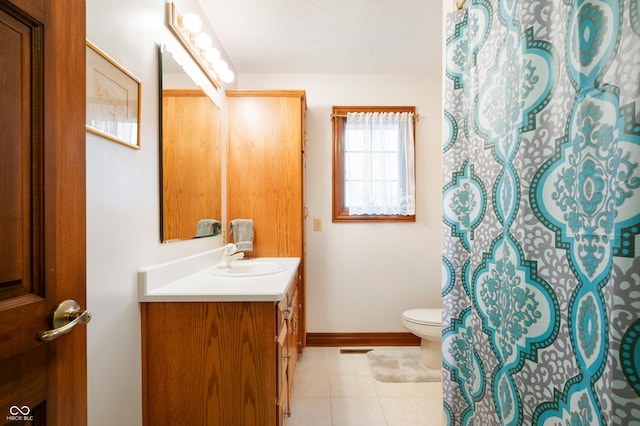 bathroom with tile patterned flooring, visible vents, baseboards, toilet, and vanity