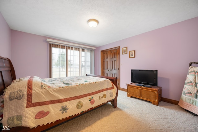 bedroom with light carpet, a closet, and baseboards