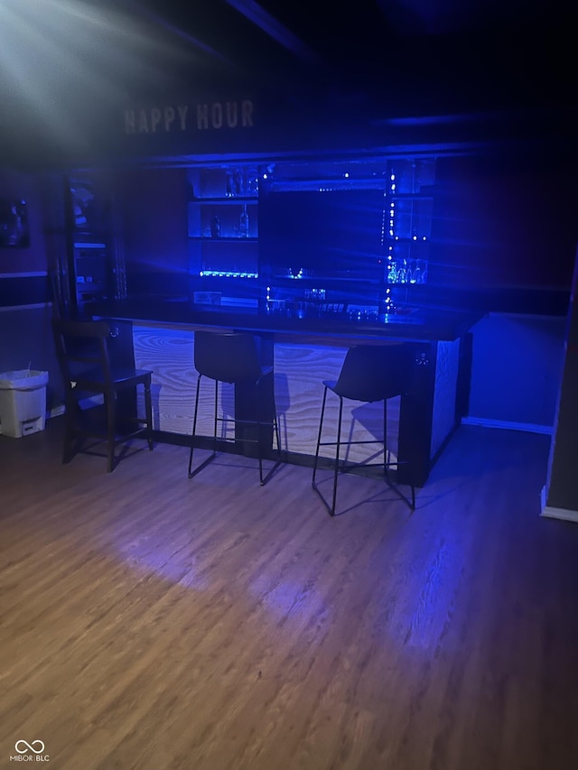 bar with baseboards and wood finished floors