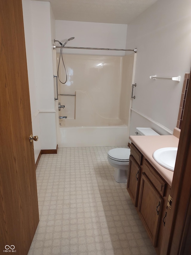 bathroom with tile patterned floors, shower / bathtub combination, toilet, and vanity