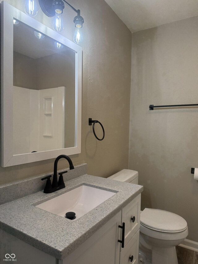 bathroom with toilet and vanity