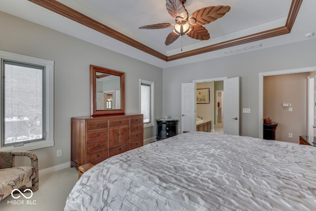 bedroom with a tray ceiling, visible vents, carpet floors, and ornamental molding