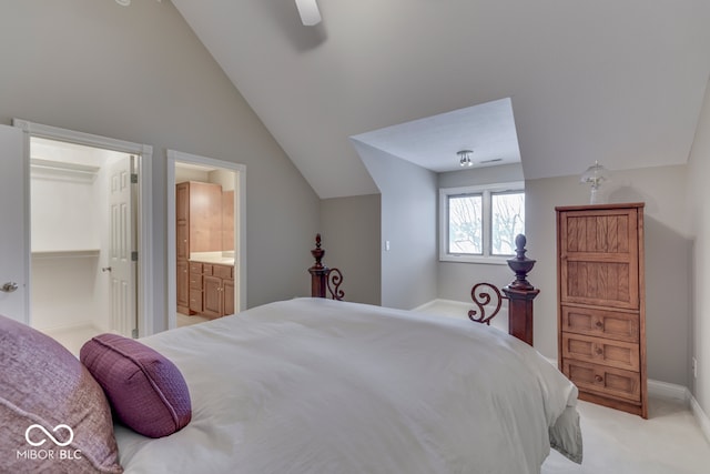 bedroom with light carpet, a ceiling fan, ensuite bathroom, lofted ceiling, and a spacious closet