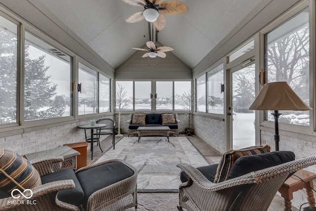 sunroom featuring plenty of natural light, ceiling fan, and lofted ceiling