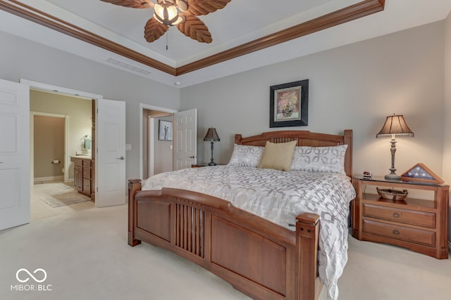 bedroom with visible vents, light colored carpet, crown molding, and a raised ceiling