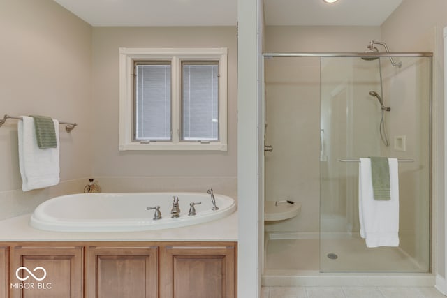 full bath with tile patterned flooring, a garden tub, and a stall shower