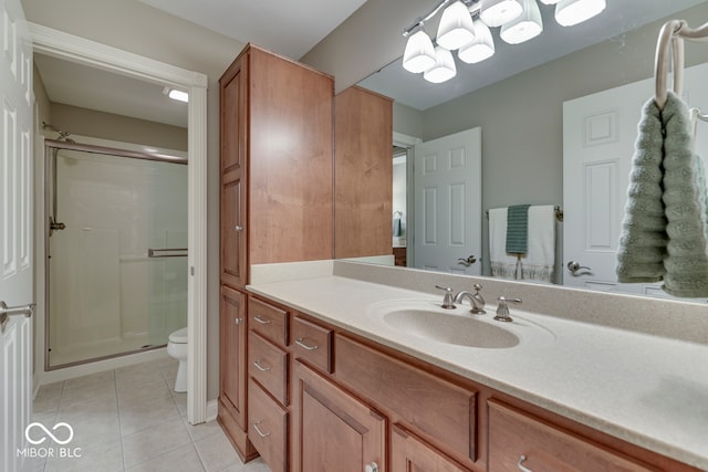 full bathroom with tile patterned flooring, toilet, a stall shower, and vanity