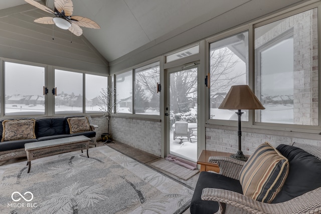 sunroom / solarium with lofted ceiling and a ceiling fan