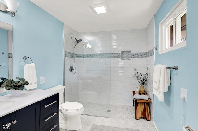 full bathroom with visible vents, toilet, tiled shower, and vanity