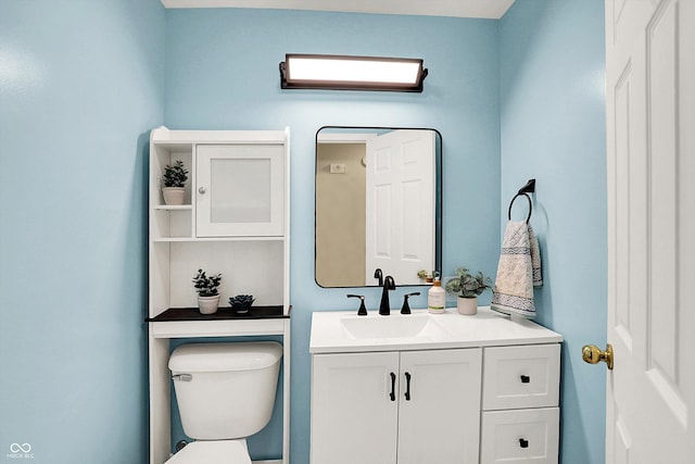 bathroom with toilet and vanity