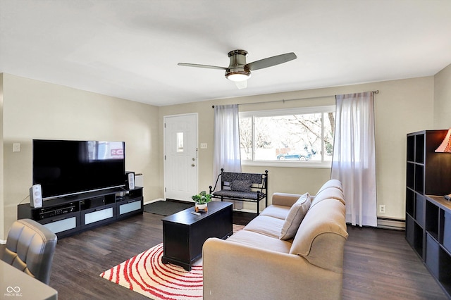 living area with baseboards, dark wood-type flooring, a ceiling fan, and a baseboard radiator