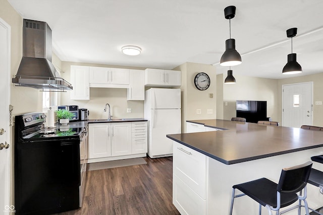 kitchen featuring a sink, dark countertops, black range with electric cooktop, freestanding refrigerator, and wall chimney range hood