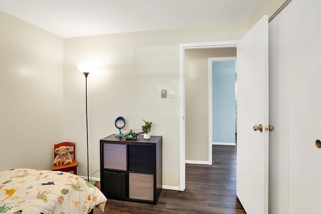 bedroom featuring baseboards and dark wood-style floors