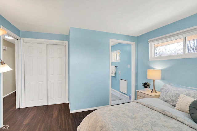 bedroom featuring a closet, radiator, baseboards, and wood finished floors