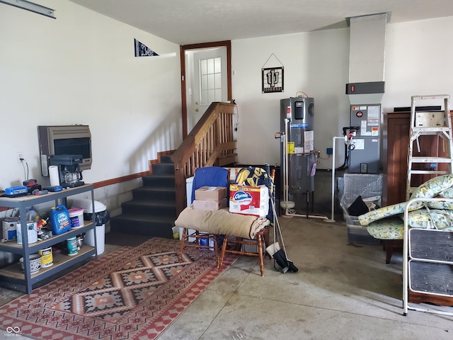 living room with stairway, hybrid water heater, and concrete floors