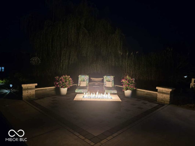 patio at night with a fire pit