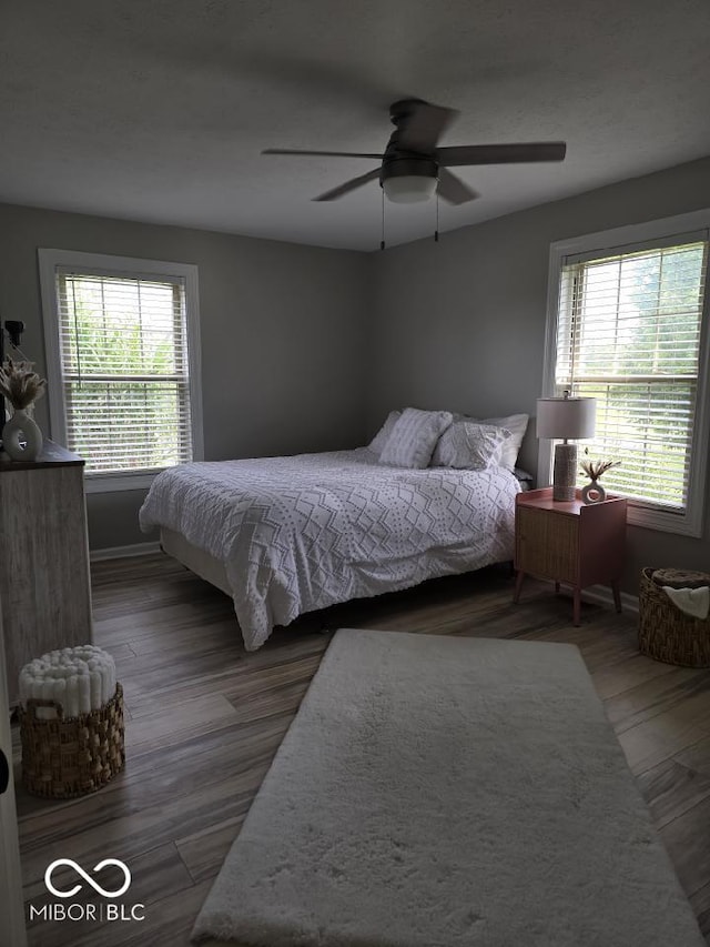 bedroom with baseboards, a ceiling fan, and wood finished floors