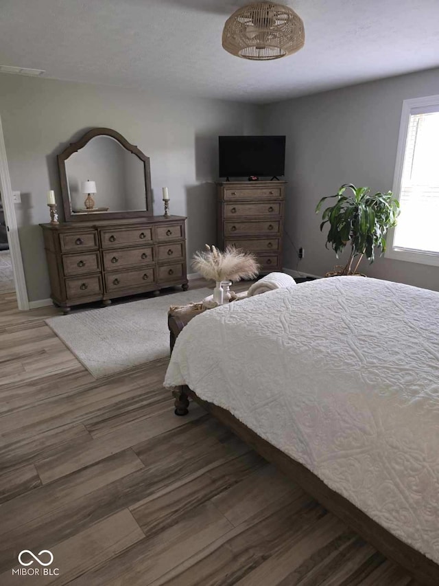 bedroom with wood finished floors