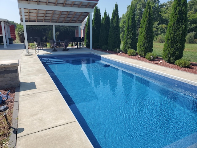 pool featuring a patio and outdoor dining area