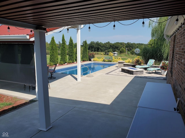 outdoor pool with a patio and an outdoor fire pit